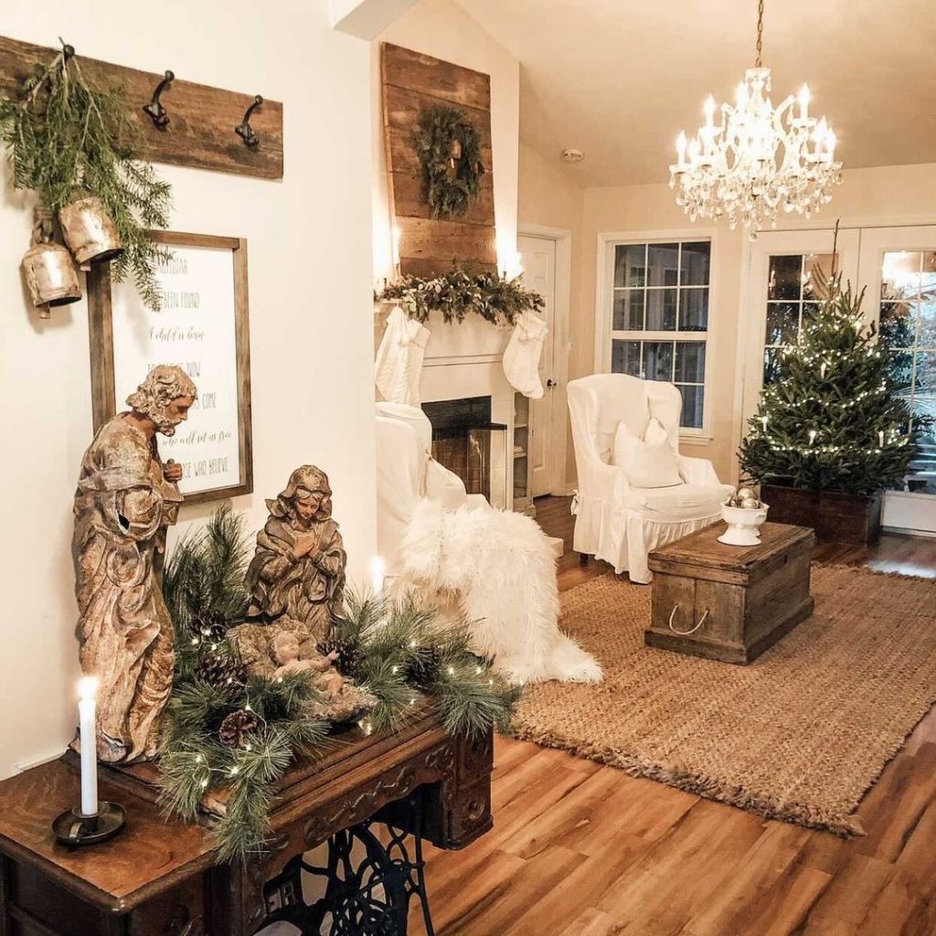 A nativity set sits in the foreground with a French Country Cottage style living room in the background.