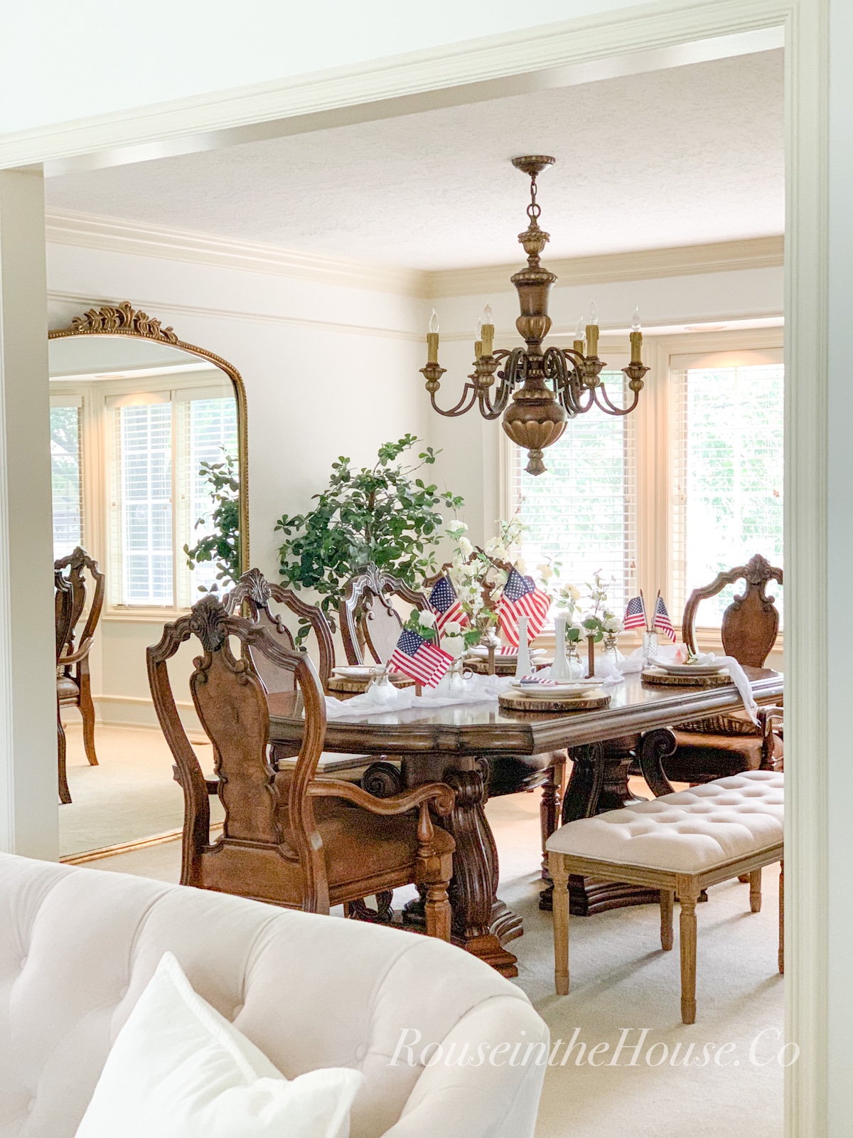 A French Country dining table is set with Americana decor for the 4th of July.