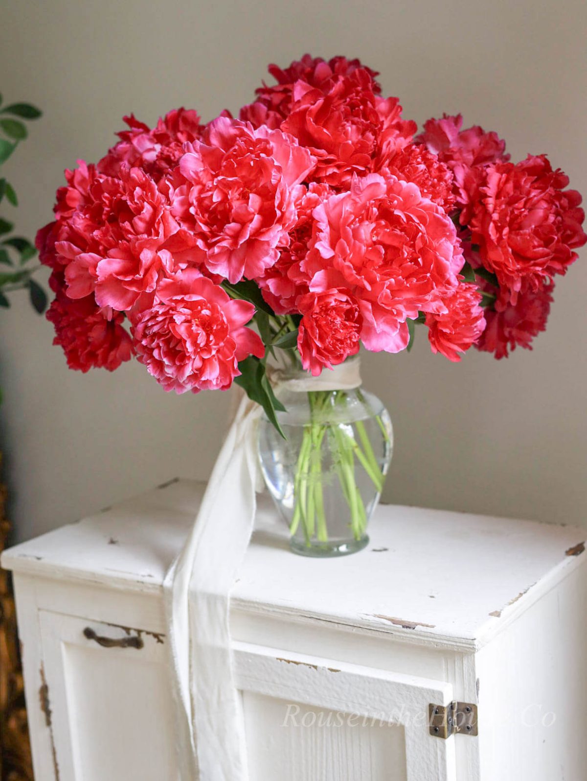 An enormous bouquet of pink peonies in an etched flower vase.