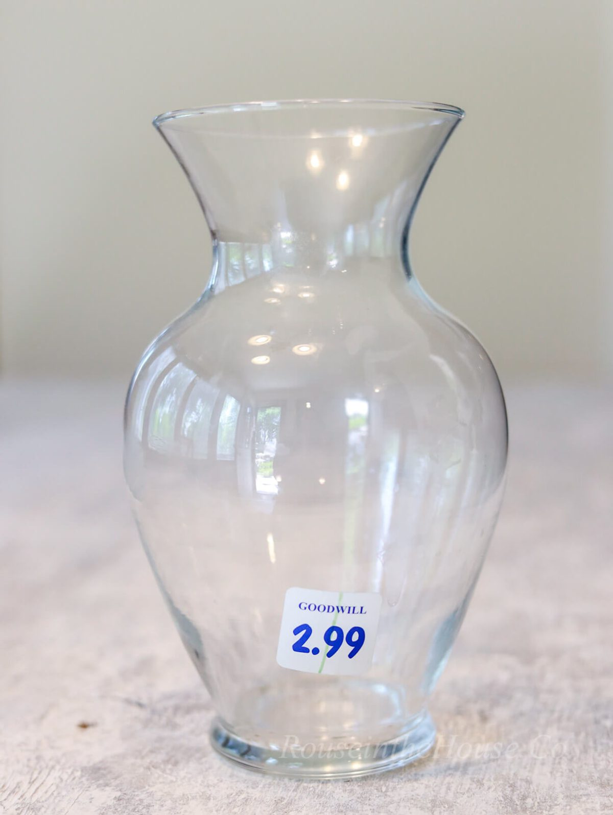 A curved glass vase from Goodwill, purchased for upcycling by etching in a French design.